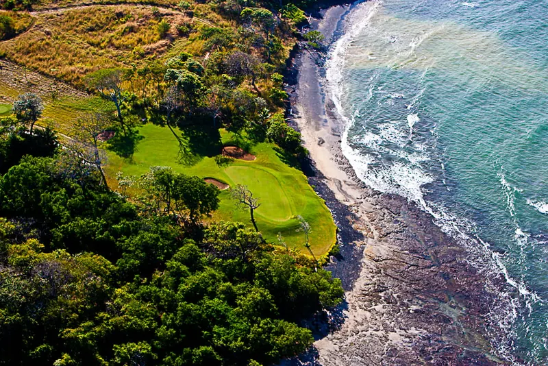 Aerial view of a golf green beside the Pacific coast