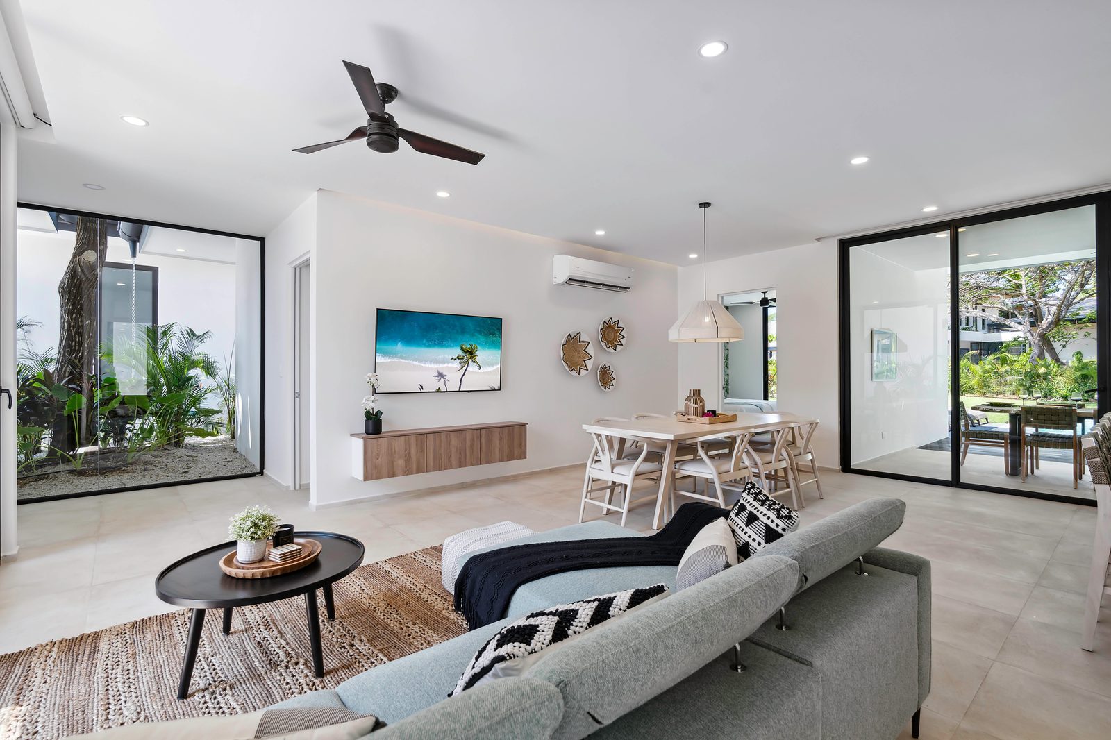 A finished Entroterra living room with timber furnishings and garden views