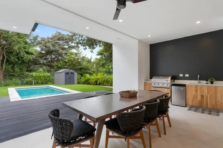 Covered dining terrace beside the pool at Casa #4