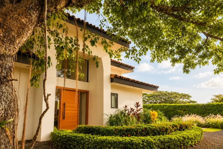 Casa Arboles entrance framed by tropical trees