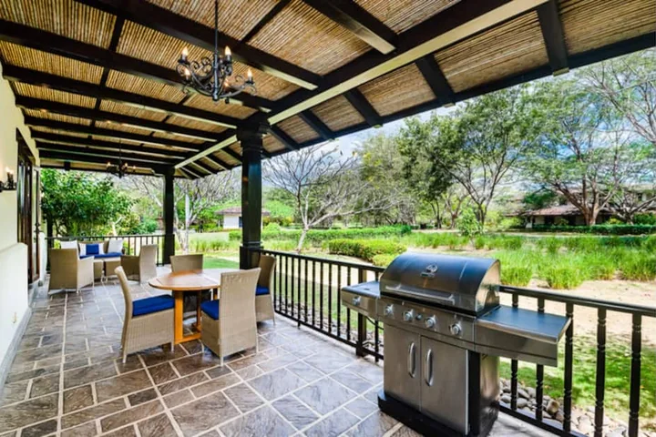 Covered dining terrace and barbecue at Casa Coral